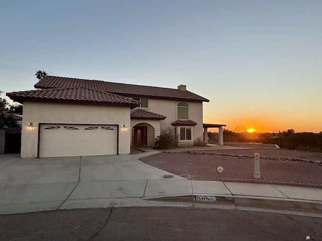 1565 W Vicky Ln, Yuma, AZ 85364 - mediterranean / spanish-style home with a garage, stucco siding, driveway, and a tile roof