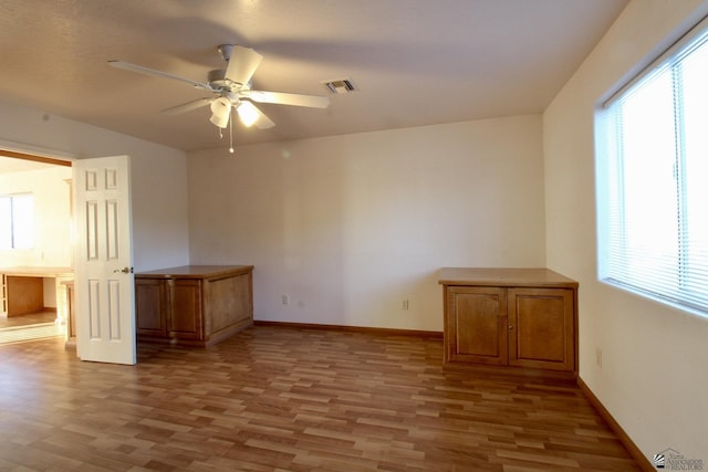 1565 W Vicky Ln, Yuma, AZ 85364 - spare room with visible vents, baseboards, ceiling fan, and wood finished floors