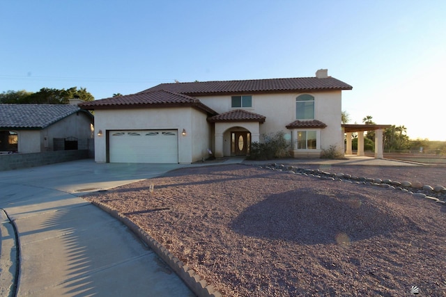 1565 W Vicky Ln, Yuma, AZ 85364 - mediterranean / spanish home featuring an attached garage, stucco siding, driveway, and a tiled roof