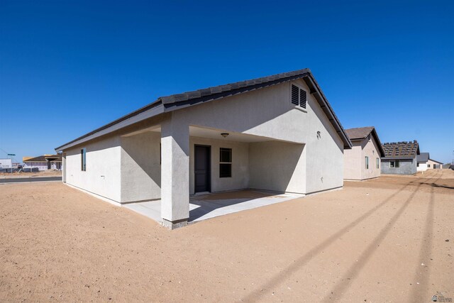10858 E 45th St, Yuma, AZ 85367 - back of property with a patio area and stucco siding