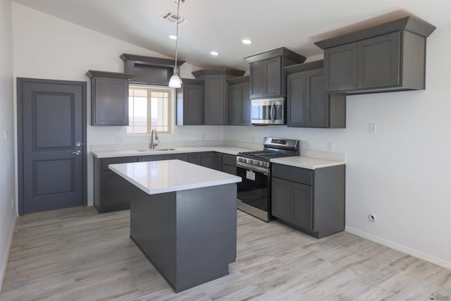 10858 E 45th St, Yuma, AZ 85367 - kitchen featuring appliances with stainless steel finishes, lofted ceiling, light wood-type flooring, light countertops, and a center island