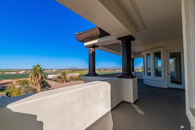 view of patio / terrace with a mountain view and a balcony