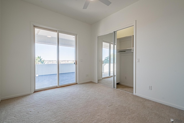 unfurnished bedroom with carpet floors, access to outside, and baseboards