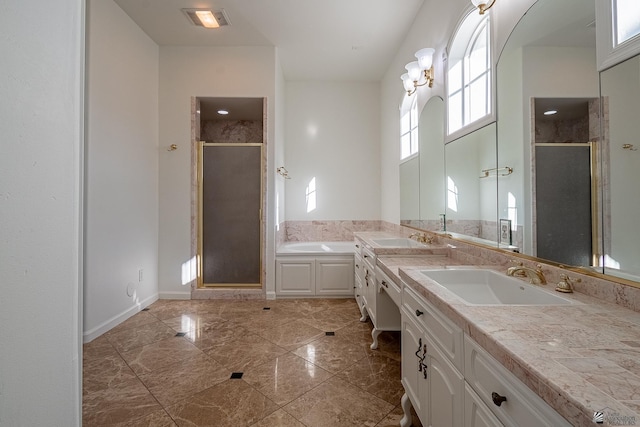 bathroom featuring double vanity, a sink, a bath, and a shower stall