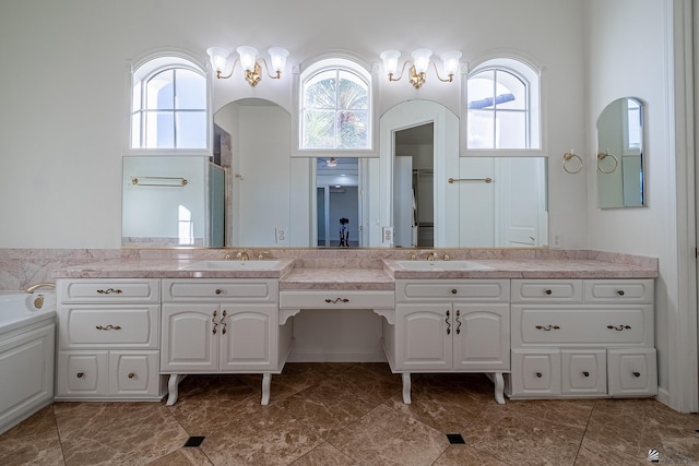 bathroom featuring a healthy amount of sunlight, a shower, and vanity