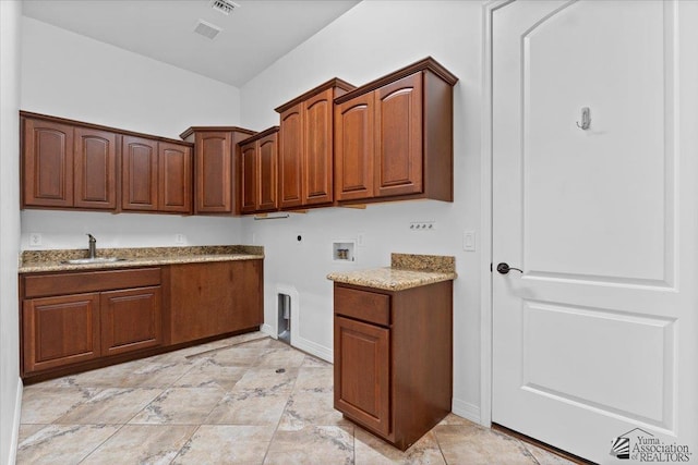 washroom with cabinet space, washer hookup, baseboards, and electric dryer hookup