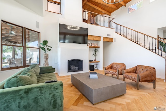 1645 W El Paseo Real, Yuma, AZ 85364 - living area with high vaulted ceiling, a wooden ceiling with exposed beams, stairs, and a fireplace