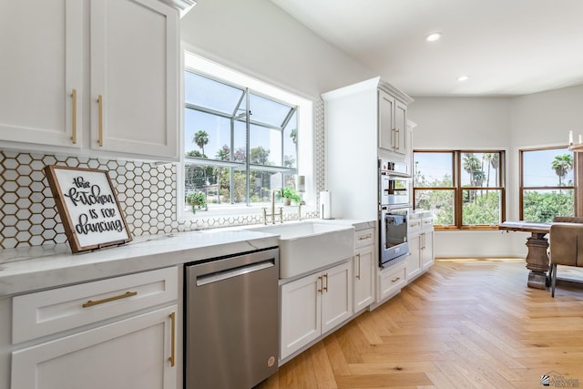 1645 W El Paseo Real, Yuma, AZ 85364 - kitchen featuring appliances with stainless steel finishes, recessed lighting, decorative backsplash, white cabinetry, and light stone counters