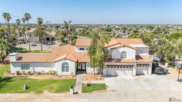 1645 W El Paseo Real, Yuma, AZ 85364 - mediterranean / spanish home with concrete driveway, a garage, stucco siding, a tile roof, and a front yard