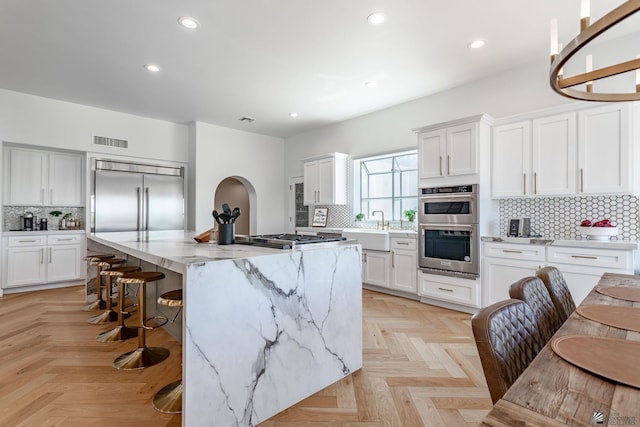 1645 W El Paseo Real, Yuma, AZ 85364 - kitchen featuring stainless steel appliances, decorative backsplash, a center island, recessed lighting, and a breakfast bar