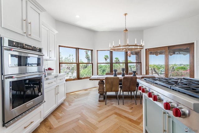 1645 W El Paseo Real, Yuma, AZ 85364 - kitchen with appliances with stainless steel finishes, recessed lighting, a chandelier, white cabinetry, and light countertops