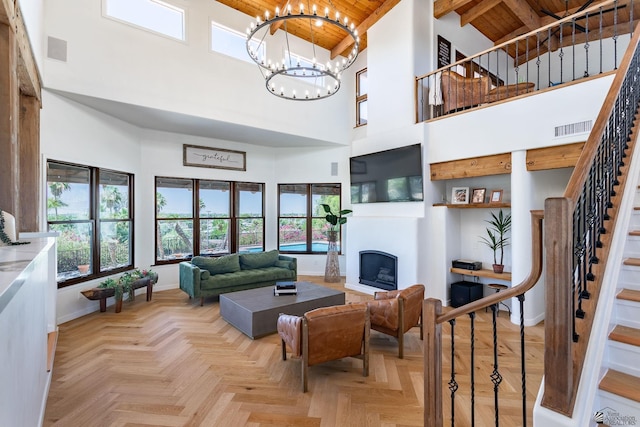 1645 W El Paseo Real, Yuma, AZ 85364 - living area with a wooden ceiling with exposed beams, high vaulted ceiling, stairs, a fireplace, and a chandelier