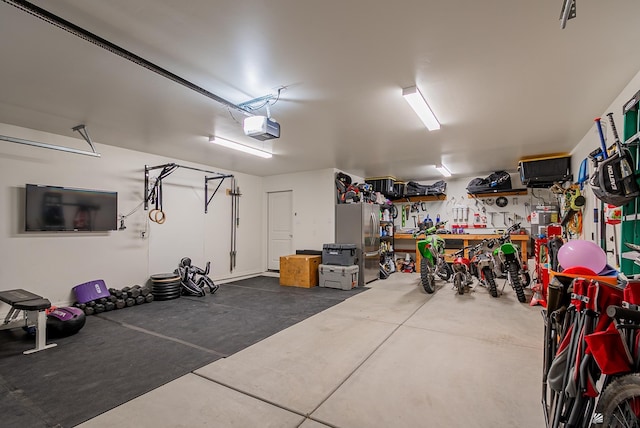 13215 S Renee Ave, Yuma, AZ 85367 - garage featuring a garage door opener and freestanding refrigerator