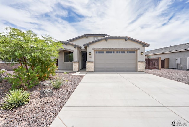7563 E 35th Ln, Yuma, AZ 85365 - view of front facade with an attached garage, concrete driveway, stucco siding, and stone siding