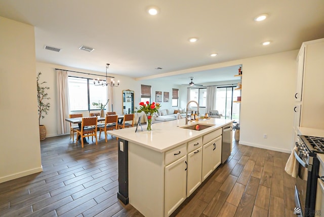 7563 E 35th Ln, Yuma, AZ 85365 - kitchen featuring a sink, appliances with stainless steel finishes, dark wood-style flooring, a center island with sink, and open floor plan