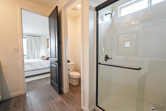 7563 E 35th Ln, Yuma, AZ 85365 - bathroom with a stall shower, toilet, connected bathroom, and wood finished floors