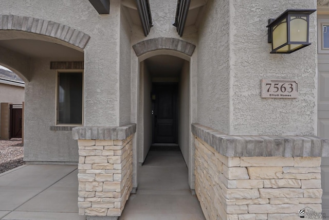 7563 E 35th Ln, Yuma, AZ 85365 - doorway to property featuring stucco siding and stone siding