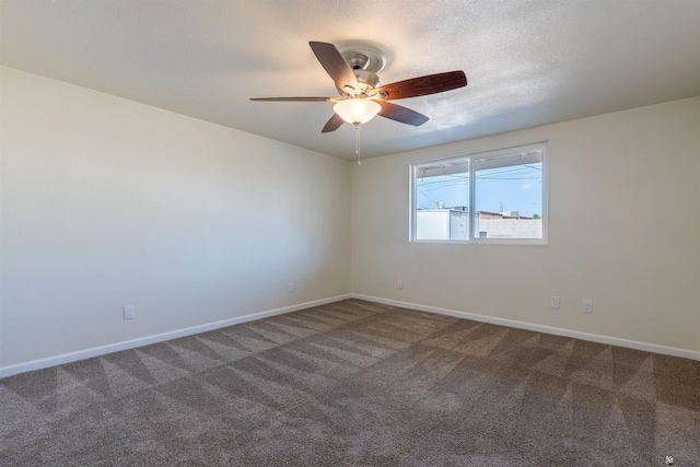 carpeted spare room with baseboards and ceiling fan