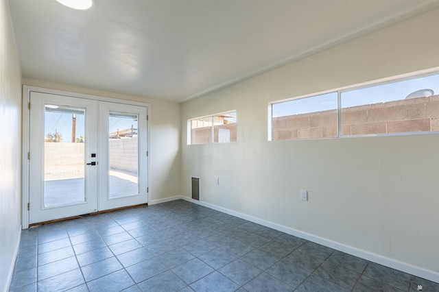 entryway featuring baseboards, french doors, and tile patterned floors