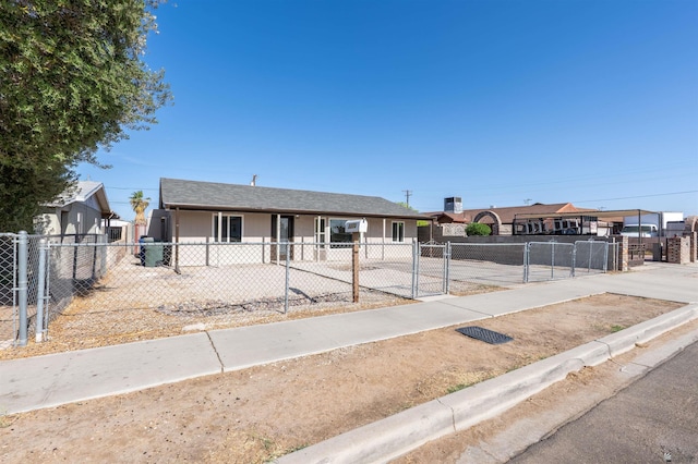 view of front of house with a fenced front yard and a gate