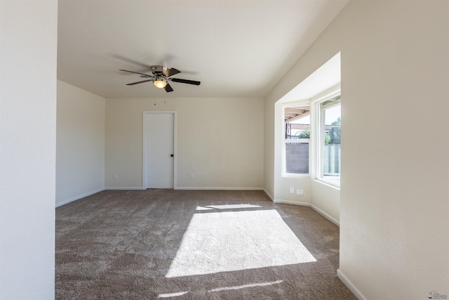 spare room with carpet flooring, baseboards, and a ceiling fan