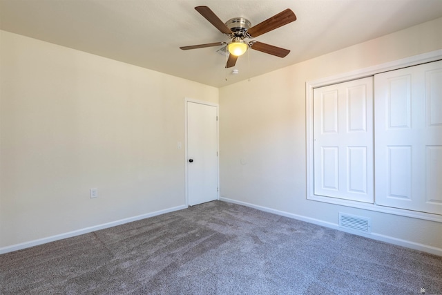 unfurnished bedroom featuring baseboards, carpet flooring, a closet, and visible vents