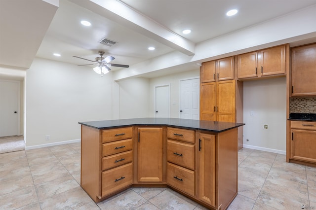 kitchen featuring a ceiling fan, brown cabinetry, recessed lighting, and a kitchen island
