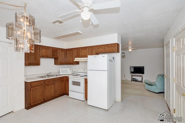 12614 E 45th Dr, Yuma, AZ 85367 - kitchen with a sink, white appliances, brown cabinetry, a ceiling fan, and under cabinet range hood