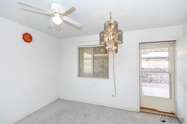 12614 E 45th Dr, Yuma, AZ 85367 - unfurnished room with baseboards, light floors, and ceiling fan with notable chandelier