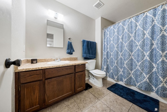 bathroom with visible vents, vanity, curtained shower, toilet, and tile patterned floors