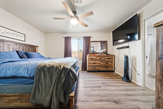 bedroom with a ceiling fan and wood finished floors