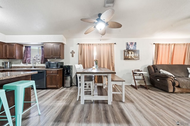 kitchen with dark brown cabinetry, ceiling fan, light wood-style floors, dishwasher, and stainless steel microwave