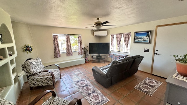13725 E 46th St, Yuma, AZ 85367 - tiled living room with a ceiling fan, a textured ceiling, a wealth of natural light, and a wall mounted air conditioner