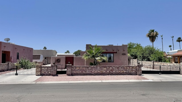 13725 E 46th St, Yuma, AZ 85367 - southwest-style home featuring a gate, a fenced front yard, and stucco siding
