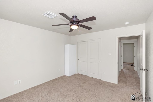 11561 E 25th Pl, Yuma, AZ 85367 - unfurnished bedroom with light colored carpet, a closet, and ceiling fan