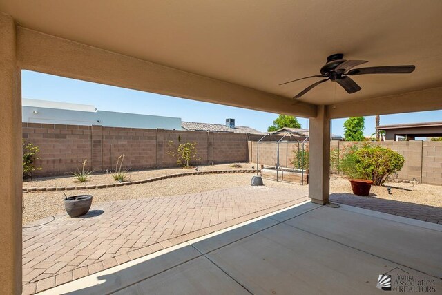 11561 E 25th Pl, Yuma, AZ 85367 - fenced backyard featuring a ceiling fan and a patio area