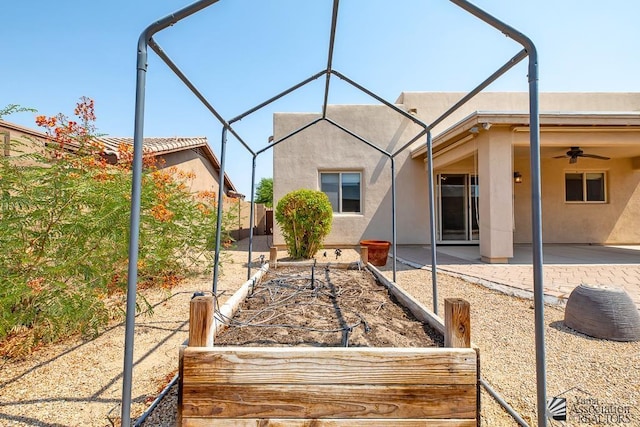 11561 E 25th Pl, Yuma, AZ 85367 - rear view of house with stucco siding, a patio area, a garden, and ceiling fan