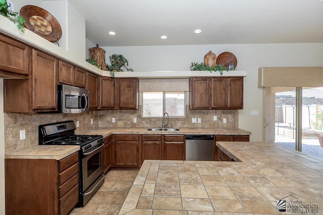 11561 E 25th Pl, Yuma, AZ 85367 - kitchen featuring stainless steel appliances, tasteful backsplash, tile countertops, healthy amount of natural light, and recessed lighting