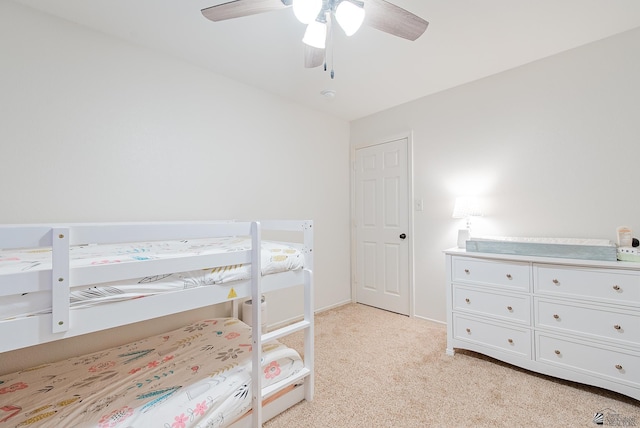 bedroom featuring a ceiling fan and light colored carpet