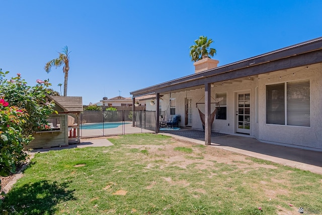 view of yard with fence, a fenced in pool, and a patio