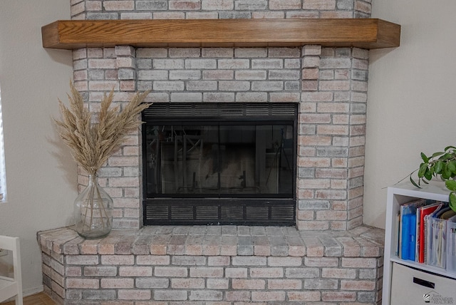 interior details with a brick fireplace