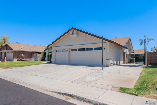 ranch-style home featuring fence, a garage, stucco siding, a gate, and driveway