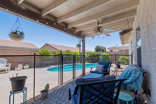 view of swimming pool with a fenced backyard, a ceiling fan, a fenced in pool, and a patio area