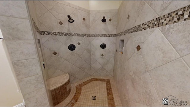 full bath featuring a tile shower