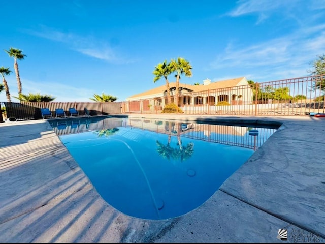 view of swimming pool with a fenced in pool, fence, and a patio