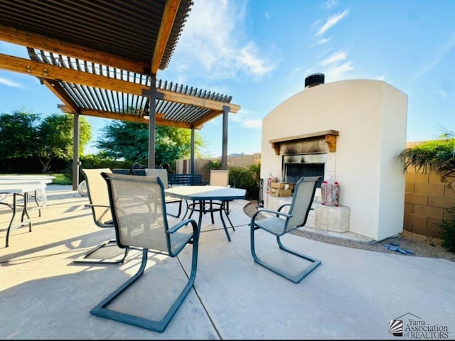 view of patio / terrace featuring fence, a pergola, outdoor dining area, and a fireplace