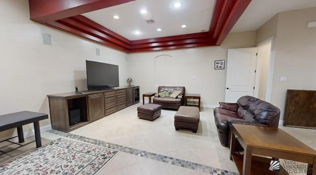 living room with recessed lighting, baseboards, light tile patterned floors, and a tray ceiling