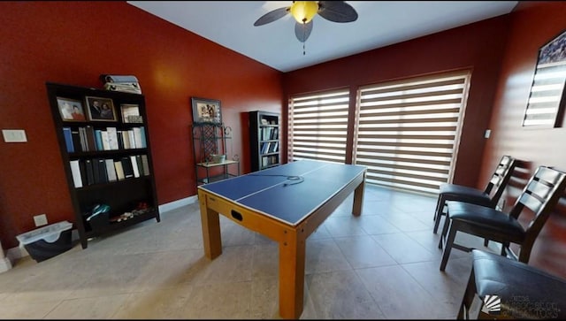 playroom with a ceiling fan, baseboards, tile patterned floors, and lofted ceiling