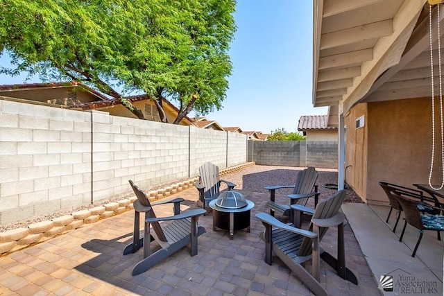 4452 S Agave Ave, Yuma, AZ 85365 - fenced backyard with an outdoor fire pit and a patio