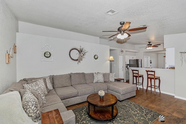 4452 S Agave Ave, Yuma, AZ 85365 - living area with dark wood finished floors, ceiling fan, and a textured ceiling